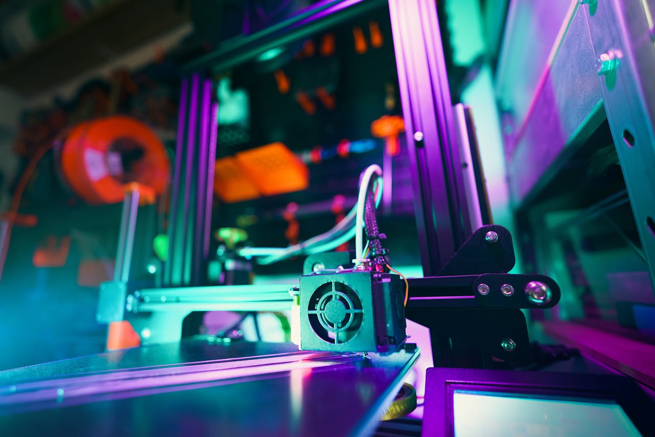 A close-up of a 3D printer in a neon-lit workshop, capturing technology and creativity.